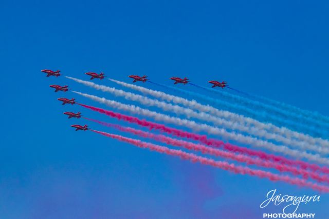 Aerobatic team trailing red, white and blue smoke