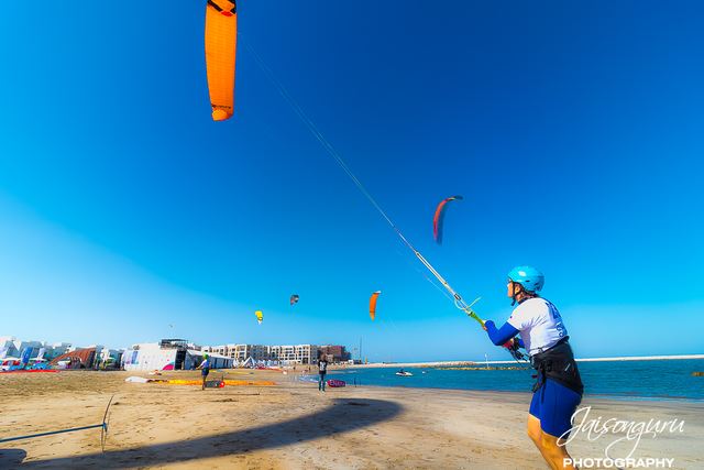 Kitesurfer leaning off the board with the kite overhead