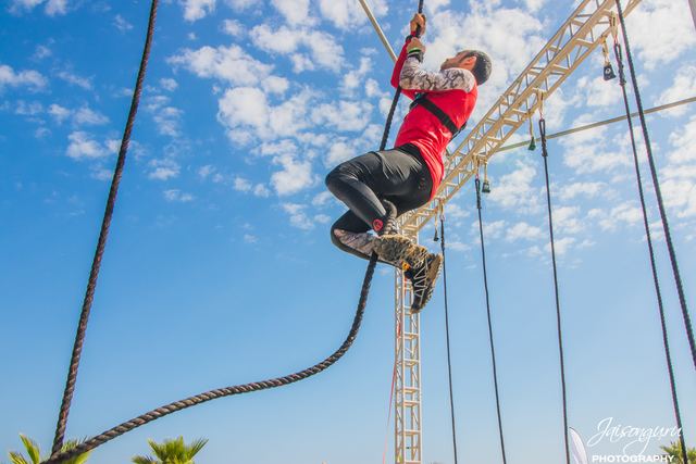 Competitor swinging between obstacles on the rig
