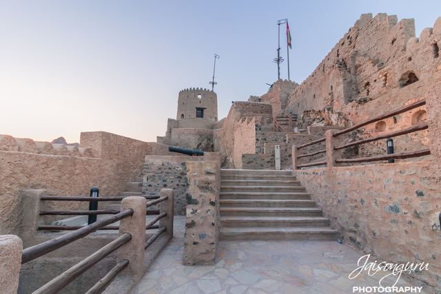 Stone steps climbing into a restored fort