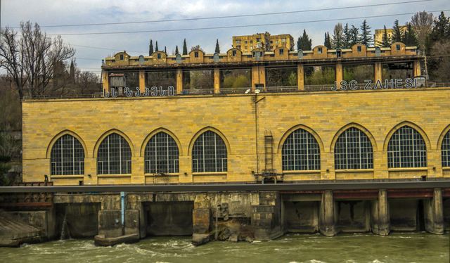 Arched facade of a historic building reflected in still water