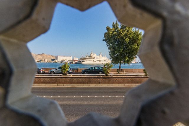 The harbour framed through a carved star-shaped opening in a wall
