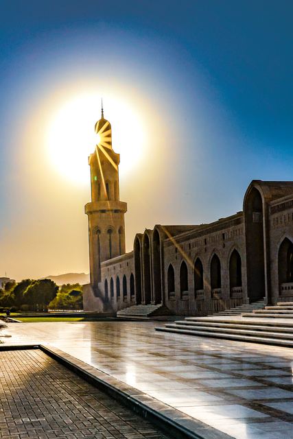 Wide view of the Grand Mosque with the sun low behind the minaret