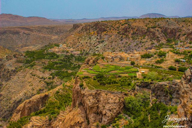 Terraced mountain village seen across the canyon