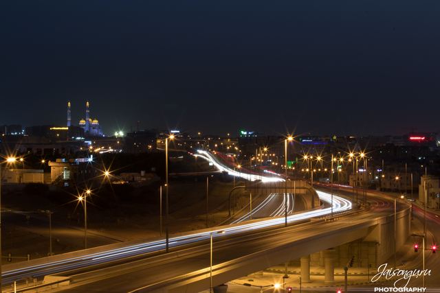 Traffic trails winding through the city at dusk