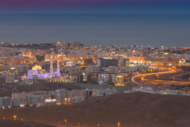 City lights spread below the hills at blue hour