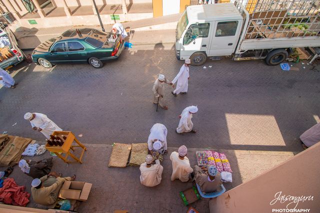 Street market seen from above, vendors laid out on the tarmac