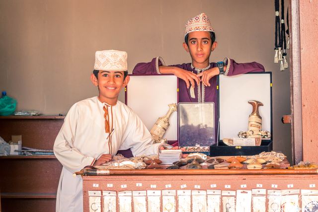 Two young stallholders behind a display of frankincense and perfume
