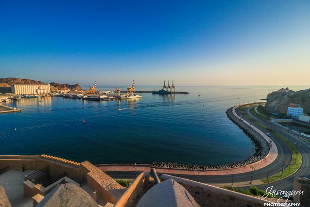 The curve of the corniche road along the bay seen from a fort wall